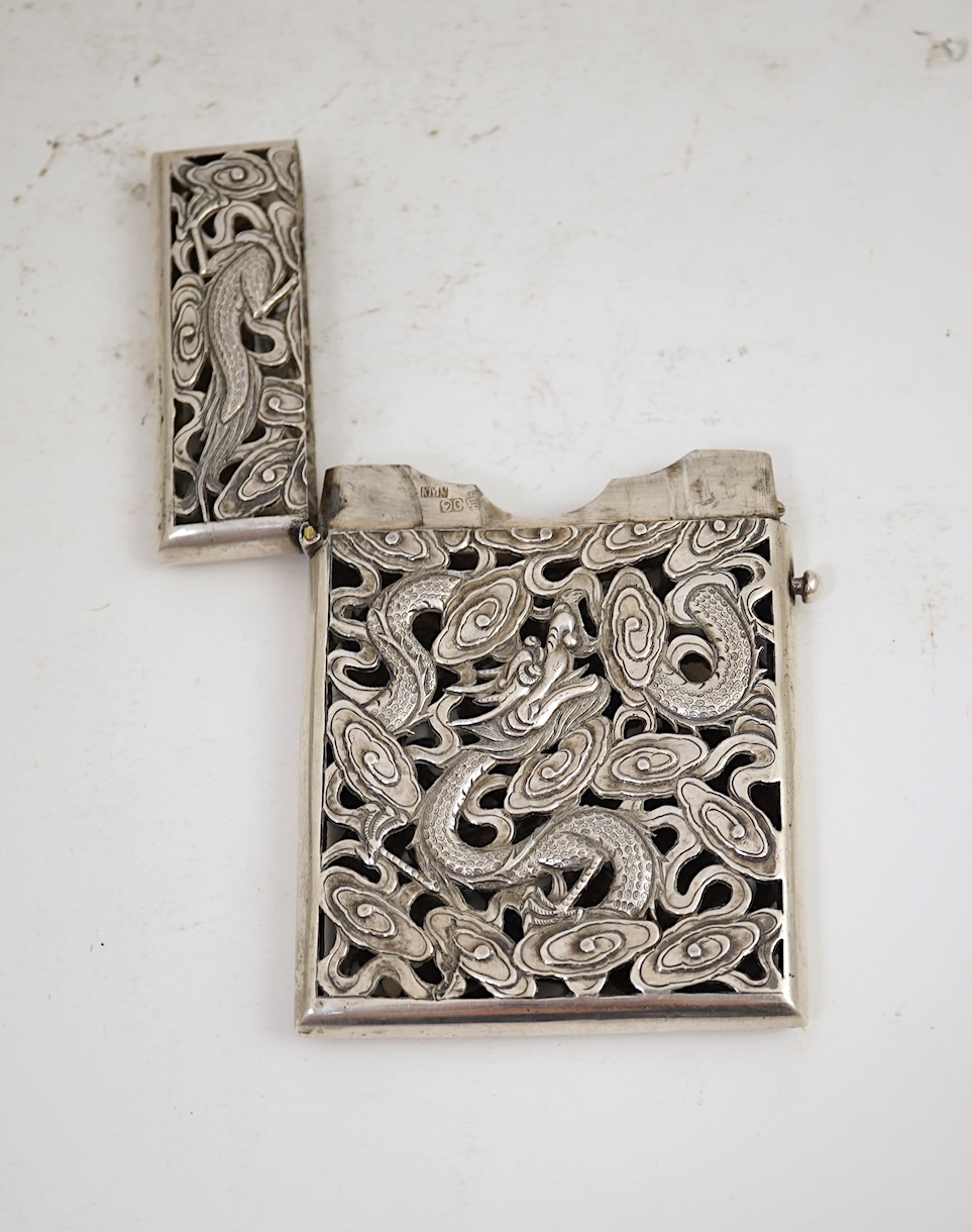 A late 19th century Chinese Export pierced silver card case, maker KMS(Kwong Man Shing), decorated with dragons amid clouds, 10.4cm, together with a Chinese Export pierced silver octagonal box and cover, by Luen Wo?, cir